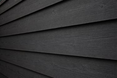 un bardage en bois peint avec de la peinture suedoise noir de falun mate en gros plan