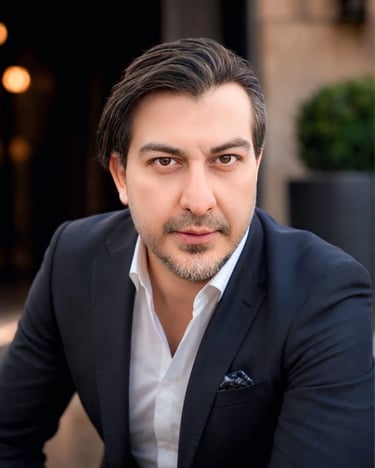 Professional portrait of a confident man wearing a navy blue blazer and white dress shirt.