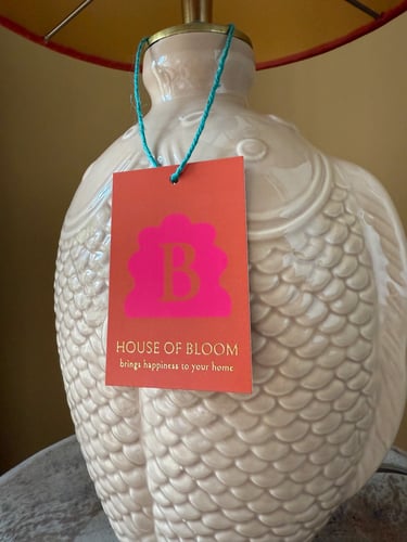 White ceramic fish-shaped table lamp base featuring a House of Bloom designer hang tag.
