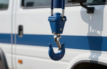 A close-up of a tow truck hook attached to a vehicle, highlighting safety and professional equipment. Daylight setting with clean #375A77 and #F5F8F9 colors.