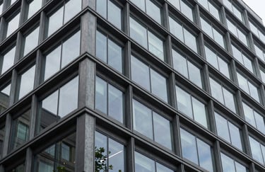 A modern architectural detail of a professional building in the Pacific Northwest, North American style. The composition focuses on geometric lines and glass, reflecting intelligence and stability.