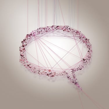 A 3D abstract speech bubble made of pink geometric shards and strings representing digital communication.