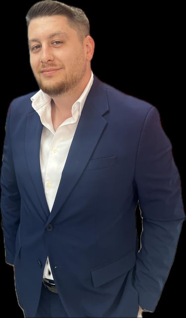 Professional portrait of a man wearing a navy blue blazer and a white button-down shirt.