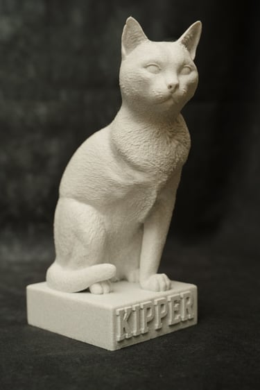A photograph of the finished 3-D print model of Kipper a three legged cat