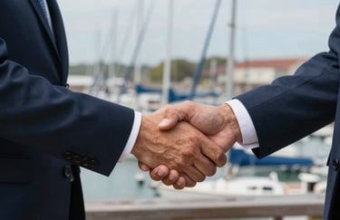 A close-up of two professionals shaking hands in front of a marina background, North American professional attire, signifying a successful agreement.