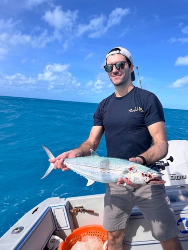 Man holding a mackerel on a charter boat in key west