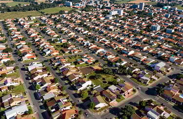 Aerial view of a modern residential neighborhood in Hortolândia, well-planned streets, green areas, bright daylight, South American real estate drone photography.