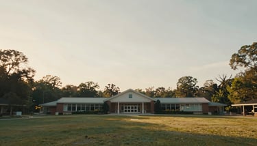 An overhead view of a diverse group of people sitting in a circle for a community counseling session, emphasizing compassionate service.