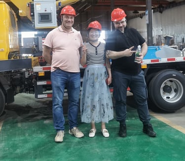 Customers from Mexico and our excellent salesmen take photos in front of our loader cranes.