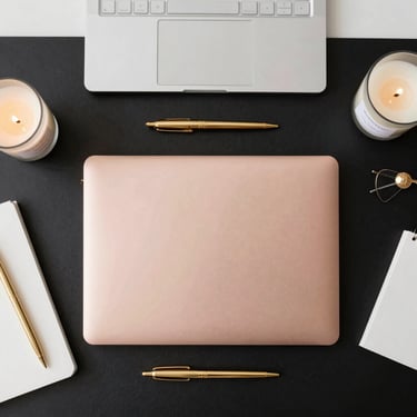 Close-up of a luxury resume with elegant black and rose gold accents on a minimalist desk.