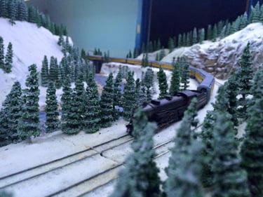 A steam powered passenger train runs through Moose Jaw Gully