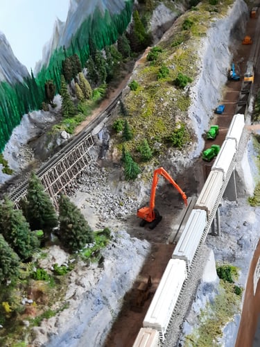A freight train heads up the new deviation at Harper Creek. Old line on the left.
