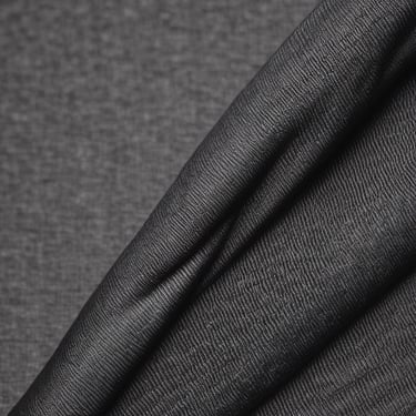 A person standing in the dirt with their feet up