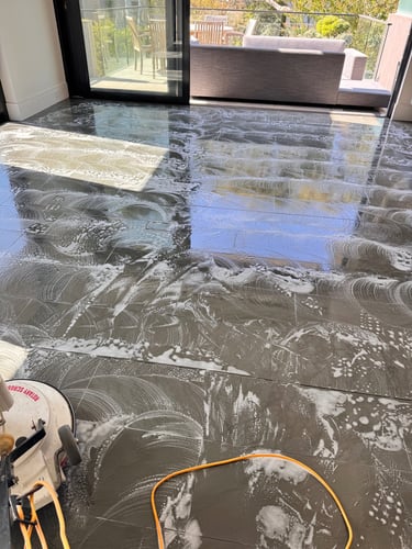 cleaning tiled floor using scrubber