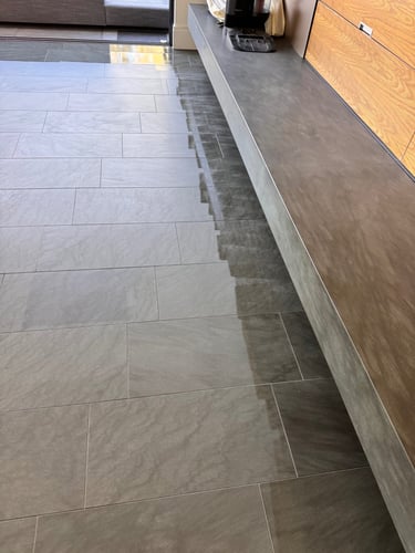 applying colour enhancing sealer to natural tiled floor