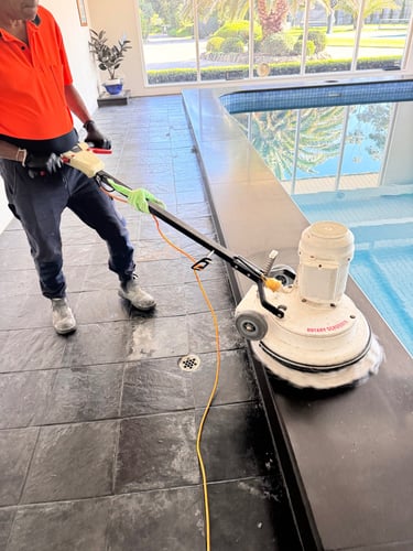 buffing blue stone tiled area around the pool