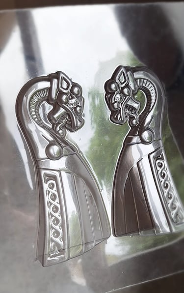 Two clear plastic Viking dragon ship molds for chocolate making
