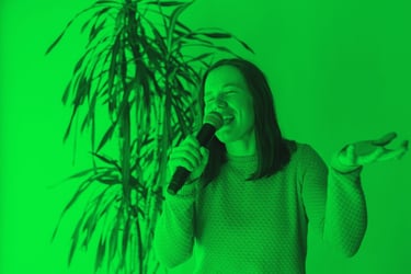 Una chica cantando con duda pero intentando