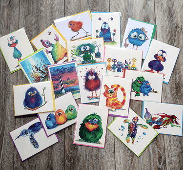 Collection of colorful whimsical greeting cards featuring cute monsters, birds, and sea creatures.