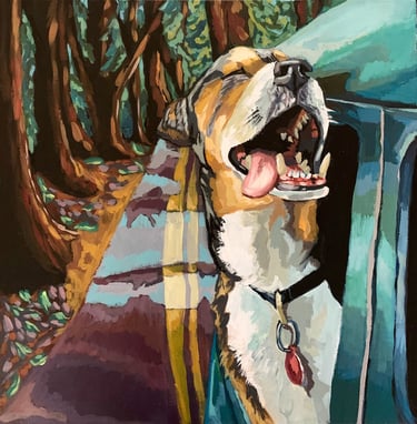 A joyful dog with his head out the window on a road trip