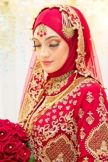 portrait of asian bride in traditional red and gold dress, light and airy photo, floral background blurred 
