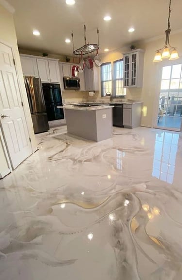 Modern kitchen featuring a high-gloss white and grey marbled epoxy floor with a central island.