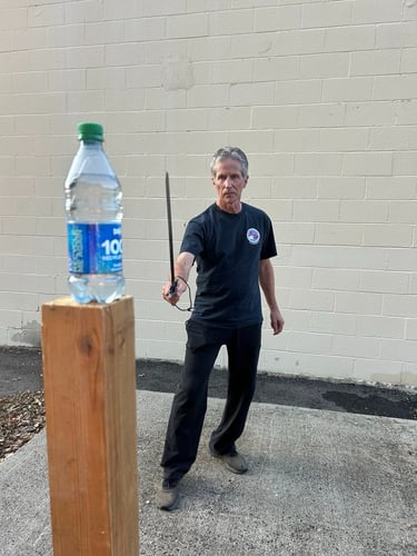 Bob test cutting with a sharpened steel Jian.