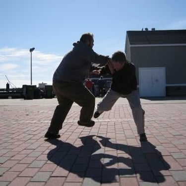 Instructor practicing San Shou against a larger opponent