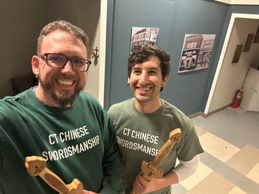 Neil and Ryan smiling after a rigorous Jianfa training session.