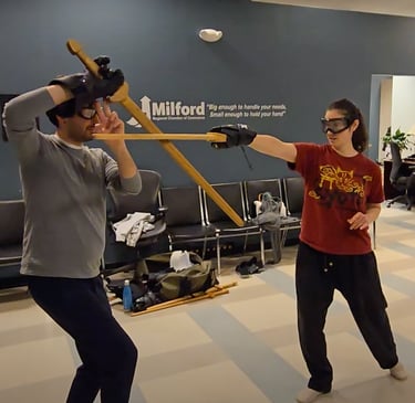 Two students in light free form sparring.
