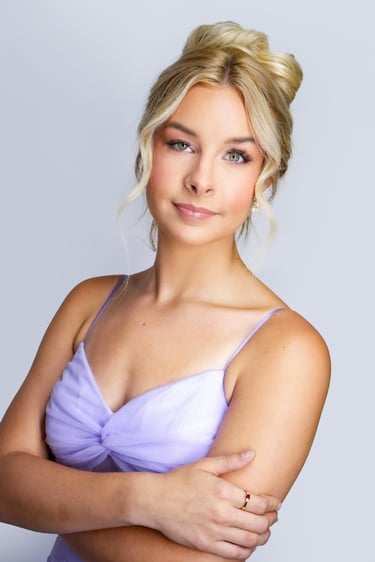 Bride with blonde hair in elegant updo, soft glam wedding makeup, glowing skin, long lashes, and natural pink lip color in la