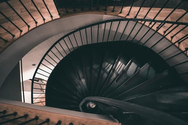 A spiral staircase going down that hints towards the depth in psychotherapy