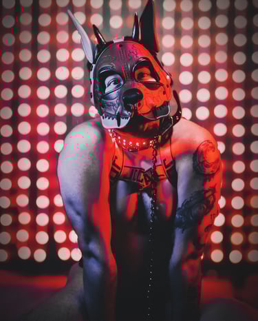 Man posing in a pup mask and gear.