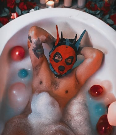 Man in the bath wearing a pup mask.
