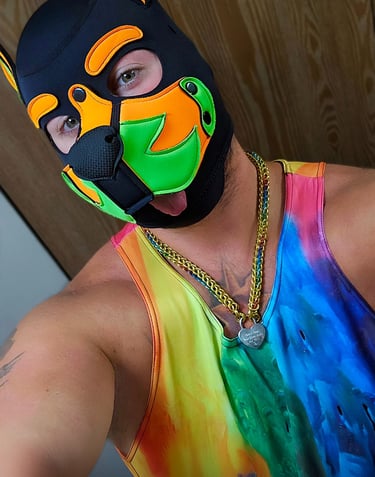 Man in pup mask and tie-dyed tank top. 