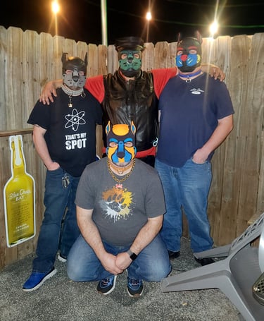 Four men in pup masks posing outdoors at a bar event.