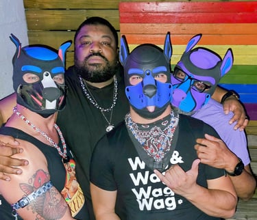 A man posing with three friends in pup masks.