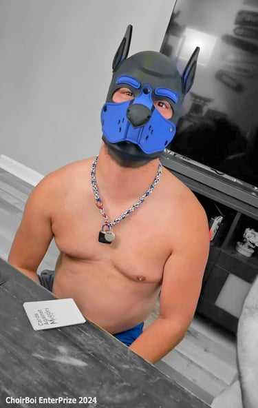 A man posing in a pup mask.