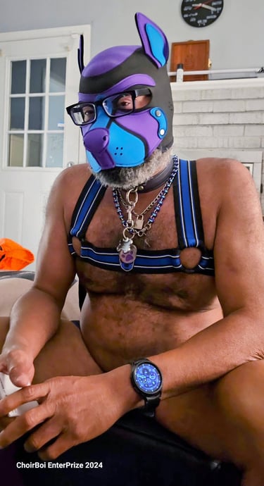 A man posing in a pup mask.
