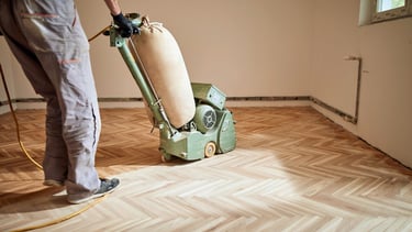 Professional flooring sanding wood floors with a belt sander. Serving Everett, Mill Creek, Mukilteo