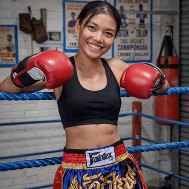 Confident female muay Thai fighter in the ring