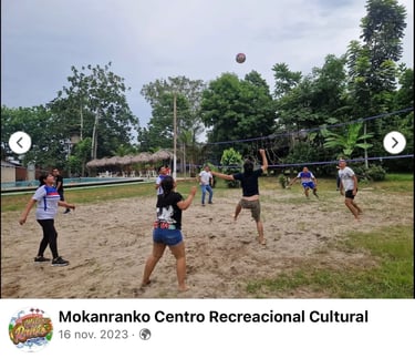 Friends playing outdoor beach volleyball at Mokanranko Centro Recreacional Cultural resort.