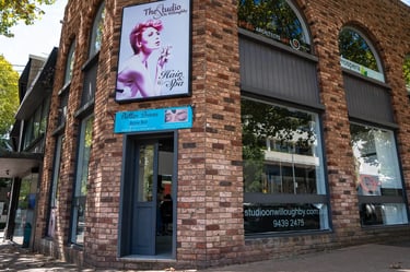 Exterior of The Studio on Willoughby, a hair and spa salon located in a red brick building.