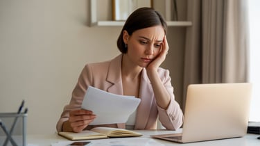 Woman overthinking finances while working, representing constant mental stress about money