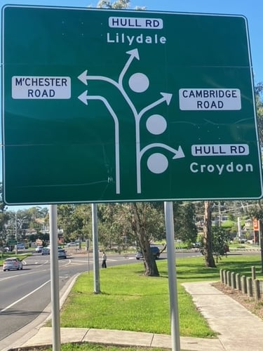 Mooroolbark round about sign guiding people to go to either Manchester Rd, Cambridge Rd or Hull Rd