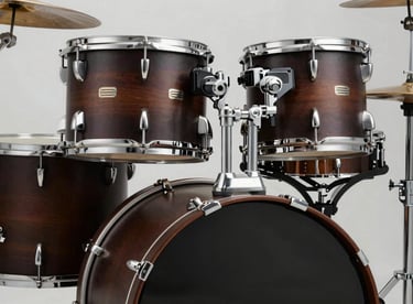 A professional set of drums in a deep espresso matte finish, with bright metallic hardware and clean studio lighting.