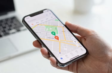 A close-up of a hand holding a smartphone displaying a map with tracking pins. High-tech interface, bright and professional lighting.