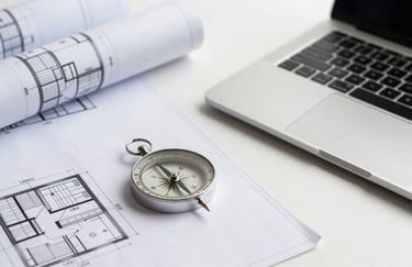 A minimalist, high-end photography of architectural blueprints and a compass laying on a clean white desk next to a professional laptop, representing precision engineering and meticulous planning.