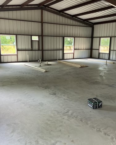 Interior of metal shed with concrete floor.