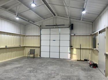 Clean interior of metal garage with spray foam insulation.